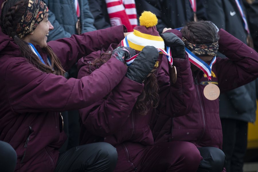 Minnesota’s Megan Hasz, Abby Kohut-Jackson, and Bethany Hasz put on their medals during the awards ceremony after the NCAA Midwest Regional on Friday, Nov. 13, 2021 at the Ashton Cross Country Course. Minnesota won the 6K race with a team score of 45, qualifying them for the NCAA Championship Nov. 20 in Tallahassee, FL. 