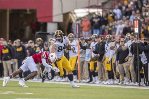 Iowa tight end Sam LaPorta attempts to stiff arm Nebraska safety Marquel Dismuke during a football game between No. 16 Iowa and Nebraska at Memorial Stadium in Lincoln, Nebraska, on Friday, Nov. 26, 2021. The Hawkeyes defeated the Cornhuskers 28-21.