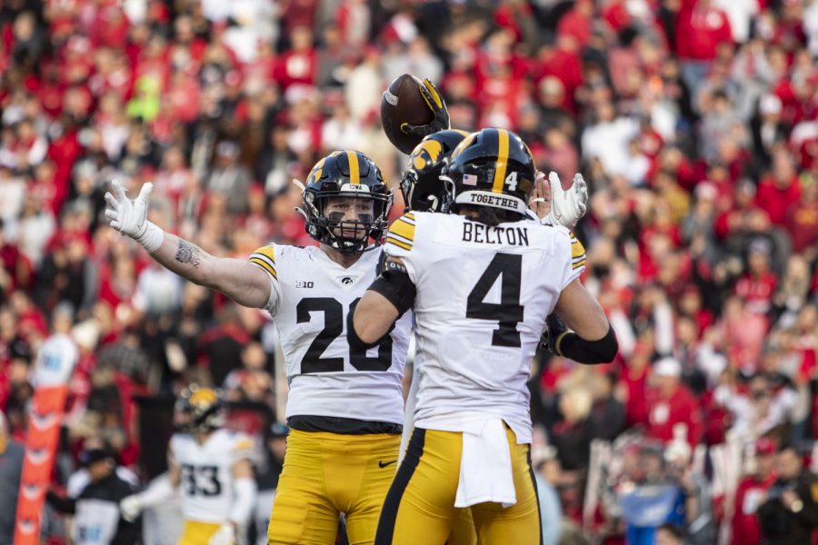 Iowa defensive backs Jack Koerner and Dane Belton celebrate with Jamari Harris after his interception during a football game between No. 16 Iowa and Nebraska at Memorial Stadium in Lincoln, Nebraska, on Friday, Nov. 26, 2021. The Hawkeyes defeated the Corn Huskers 28-21. (Grace Smith/The Daily Iowan)