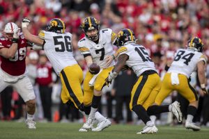 Iowa quarterback Spencer Petras hands the ball off to running back Tyler Goodson during a football game between No. 16 Iowa and Nebraska at Memorial Stadium in Lincoln, Nebraska, on Friday, Nov. 26, 2021. Goodson had 23 carries for 156 yards. The Hawkeyes defeated the Cornhuskers 28-21.