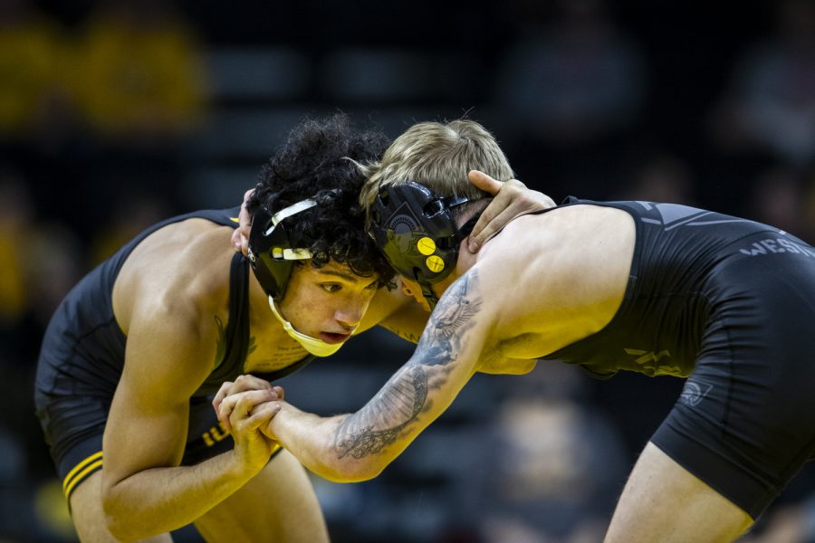 Iowa%E2%80%99s+125-pound+Jesse+Ybarra+grapples+with+Amry%E2%80%99s+125-pound+Ryan+Chauvin+during+a+wrestling+meet+between+No.+1+Iowa+and+Army+at+Carver-Hawkeye+Arena+in+Iowa+City+on+Sunday%2C+Nov.+28%2C+2021.+Ybarra+defeated+Chauvin+3-1+with+a+take+down+in+sudden+victory.The+Hawkeyes+defeated+the+Black+Knights+36-7.