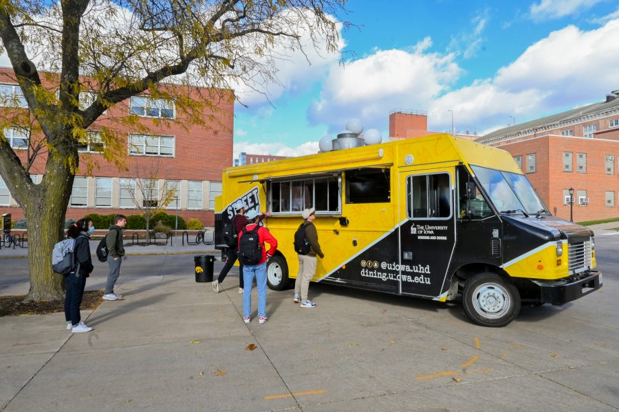Customers wait outside the beloved food truck on campus: Street Hawk, for some delicious food, November 11, 2021. The Street Hawk, run by Michael Graham and Chris Horras, has been serving the University of Iowa community for four years now!