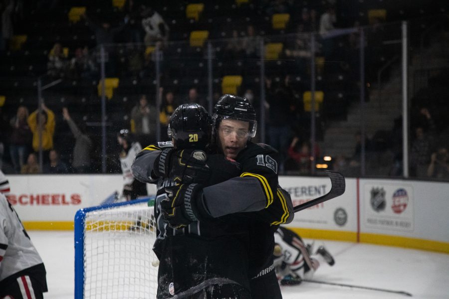 Iowa forwards Kris Bennett and Bryce Misley hug after a goal during a hockey game between the Iowa Heartlanders and Indy Fuel at the Xtream Arena in Coralville, Iowa on Friday, Nov. 12, 2021. Iowa won 5-3. 