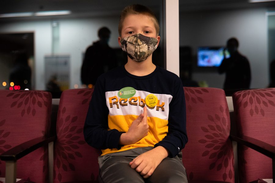 Keegan Kleppe points to his vaccination pin after getting vaccinated at the UIHC Riverside Landing Clinic in Coralville, Iowa Tuesday, Nov. 3, 2021. (Gabby Drees/The Daily Iowan)