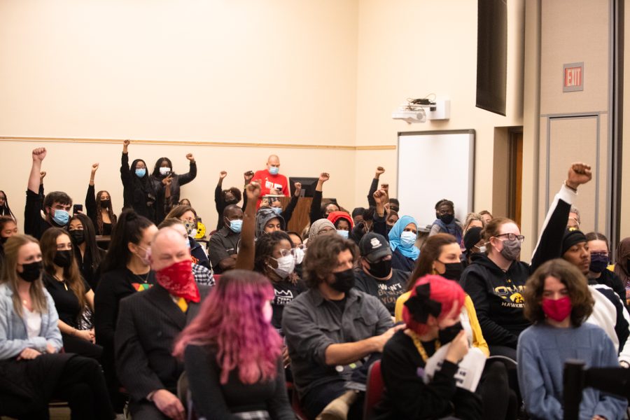 Protesters throw up their fists at a meeting of the Board of Directors at the Iowa City Community School District Administration Building in Iowa City Tuesday, Nov. 9, 2021. Community members protested after a video surfaced on social media of an Iowa City West High School student using a racial slur and blackface. 