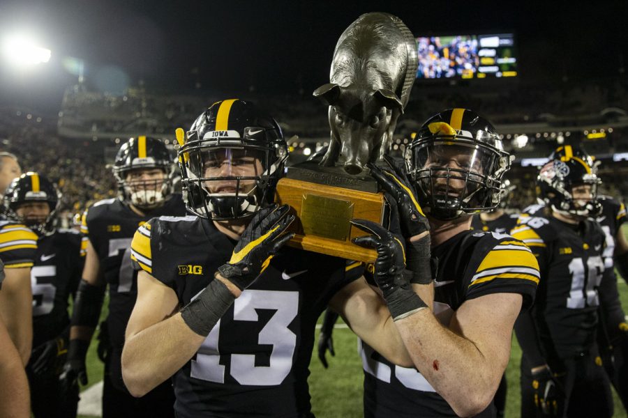 Iowa+defensive+end+Joe+Evans+and+defensive+back+Jack+Koerner+carry+the+Floyd+of+Rosedale+after+a+football+game+between+No.+19+Iowa+and+Minnesota+at+Kinnick+Stadium+on+Saturday%2C+Nov.+13%2C+2021.+The+Hawkeyes+defeated+Gophers+27-22.