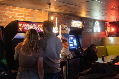 Two college customers enjoy “Classic Arcade” game at the new bar in town, Joystick Comedy Arcade, November 4, 2021. 