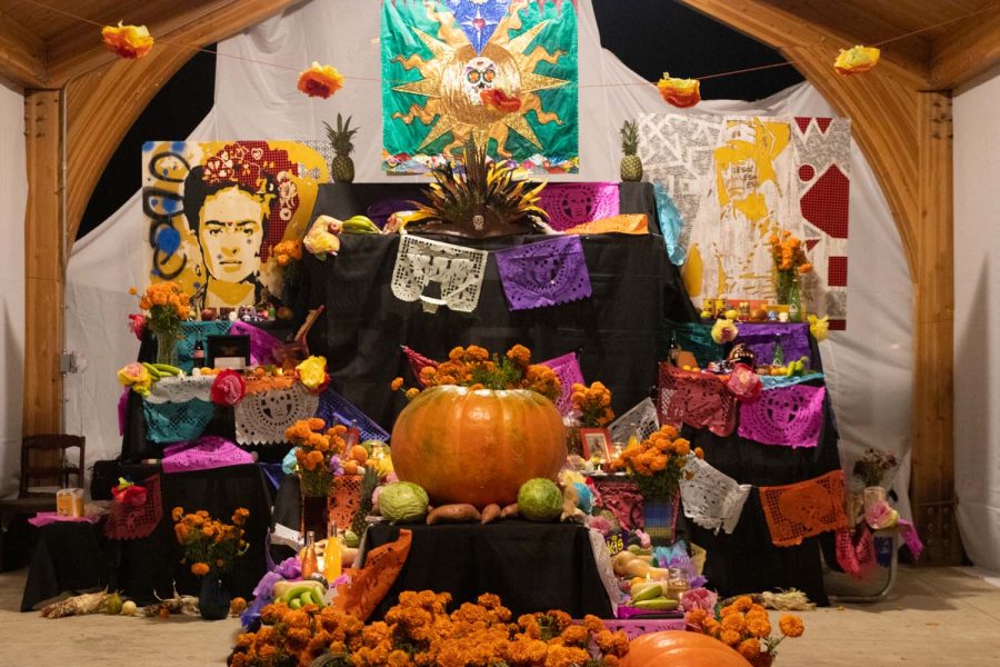 An alter created by Miriam Alarcón Avila is displayed at the Día de los Muertos ofrenda at Wetherby Park in Iowa City on Monday Nov. 1, 2021. The table has items to remember loved ones that have passed away, including flowers, candles, food, and more. 
