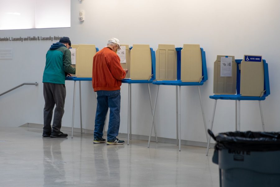 Voters vote on Election Day at the Visual Arts Building poll location in Iowa City on Monday, Nov. 1, 2021. 