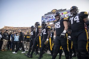 Iowa head coach Kirk Ferenzt and members of the Iowa football team walk onto the field before a football game between Iowa and Minnesota at Kinnick Stadium on Saturday, November 16, 2019. The Hawkeyes defeated the Gophers, 23-19. 
