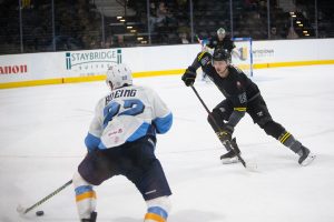 Walleye forward Brett Boeing attempts to get by Heartlander defenseman Fedor Gordeev during a hockey game between the Iowa Heartlanders and the Toledo Walleye at the Xtream Arena in Coralville, Iowa on Friday, Oct. 30, 2021. The Walleye won against the Heartlanders 10-1. 