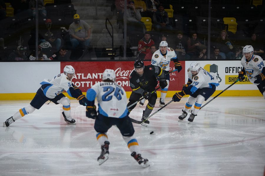 Toledo Walleye players surround forward Zach Remers during a hockey game between the Iowa Heartlanders and Toledo Walleye at the Xtream Arena in Coralville, Iowa on Friday, Oct. 29, 2021. Iowa Heartlanders lost to the Toledo Walleye 10-1. 