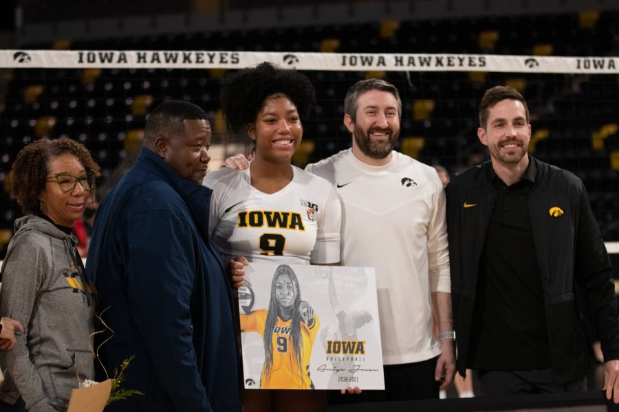 Iowa middle blocker Amiya Jones poses for a portrait with her family and assistant coaches William Tatge and Dave Brown on senior night before the volleyball match against Maryland at Xtream Arena in Coralville, IA on Saturday, Nov. 13, 2021. The Hawkeyes beat the Terrapins 3-1.