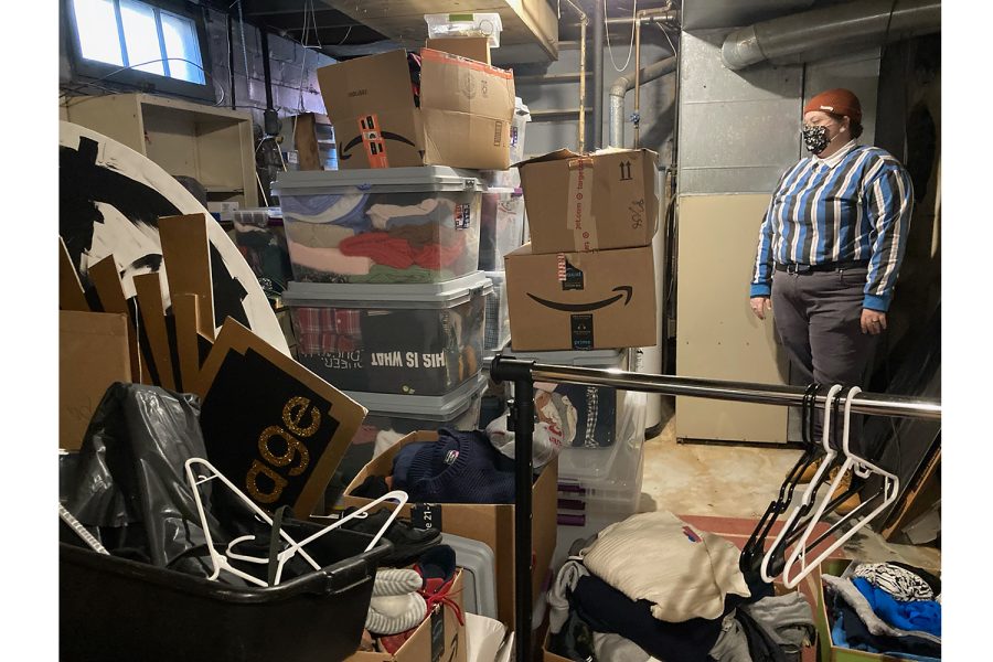 Savannah DeGroot, one of QT Closets founders and Project Coordinator, looks over a large pile of clothing donations that have been cleaned and processed for giving away. The number of clothing items in the storage containers pictured are estimated to be around 2,000.