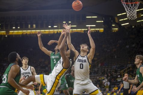 Iowa forwards Keegan Murray and Filip Rebraca fight for a rebound  during a men’s basketball game between Iowa and Slippery Rock at Carver-Hawkeye Arena in Iowa City on Friday, Nov. 5, 2021. The Hawkeyes out rebounded Slippery Rock 56-34. The Hawkeyes beat The Pride of the Rock 99-47. 