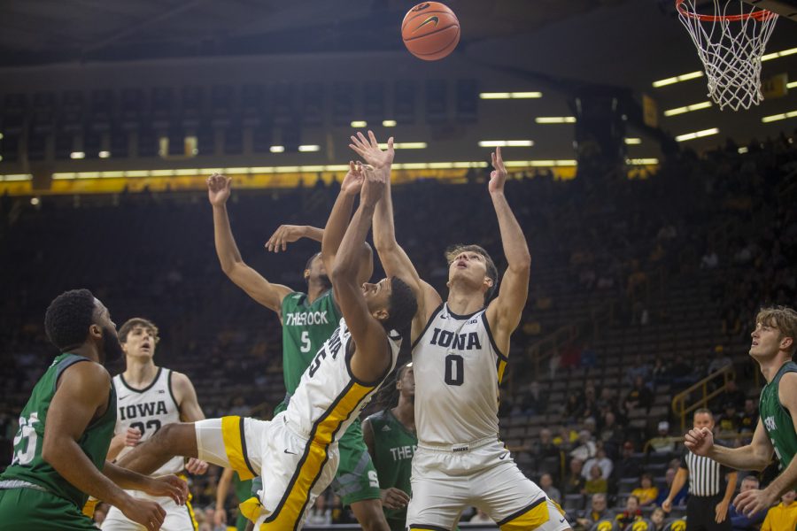 Iowa forwards Keegan Murray and Filip Rebraca fight for a rebound  during a men’s basketball game between Iowa and Slippery Rock at Carver-Hawkeye Arena in Iowa City on Friday, Nov. 5, 2021. The Hawkeyes out rebounded Slippery Rock 56-34. The Hawkeyes beat The Pride of the Rock 99-47. 
