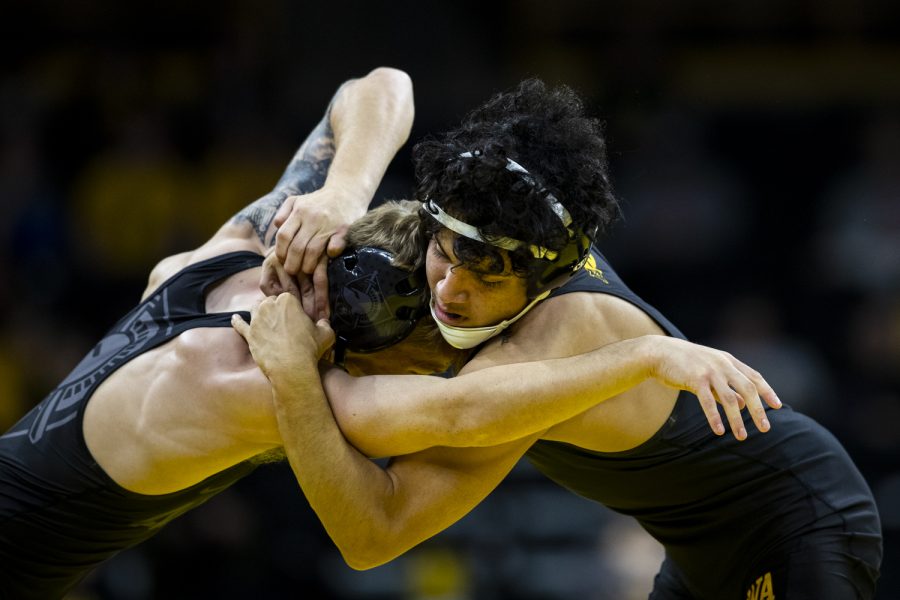 Iowa’s 125-pound Jesse Ybarra grapples with Army’s 125-pound Ryan Chauvin during a wrestling meet between No. 1 Iowa and Army at Carver-Hawkeye Arena in Iowa City on Sunday, Nov. 28, 2021. Ybarra defeated Chauvin 3-1 with a take down in sudden victory.The Hawkeyes defeated the Black Knights 36-7. 