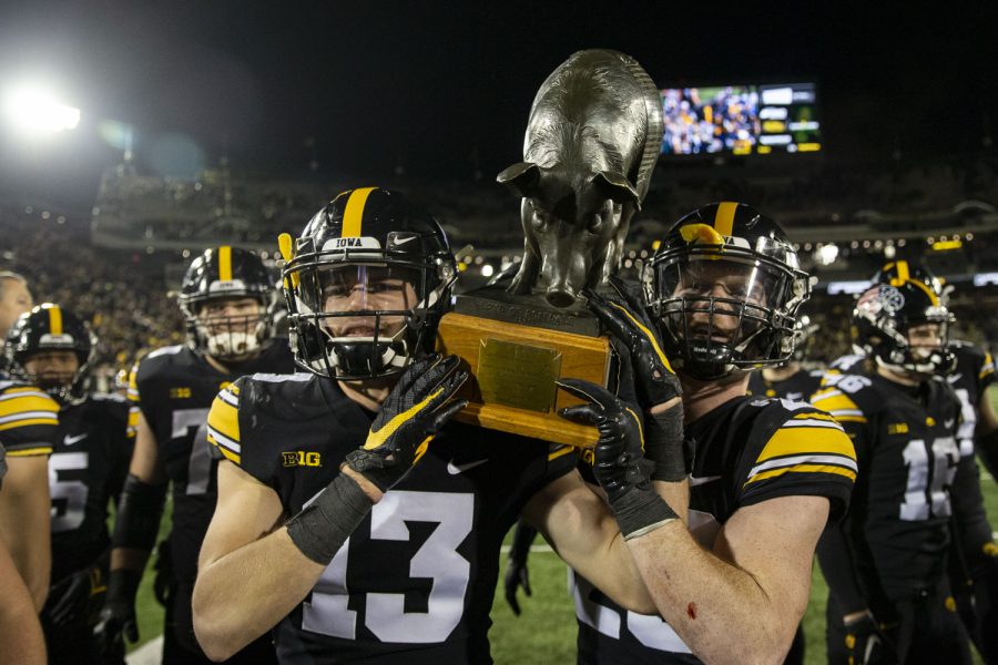 Iowa defensive backs Henry Marchese and Jack Koerner carry the Floyd of Rosedale after a football game between No. 19 Iowa and Minnesota at Kinnick Stadium on Saturday, Nov. 13, 2021. Iowa defeated the Gophers for the seventh straight year. The Hawkeyes defeated Gophers 27-22.