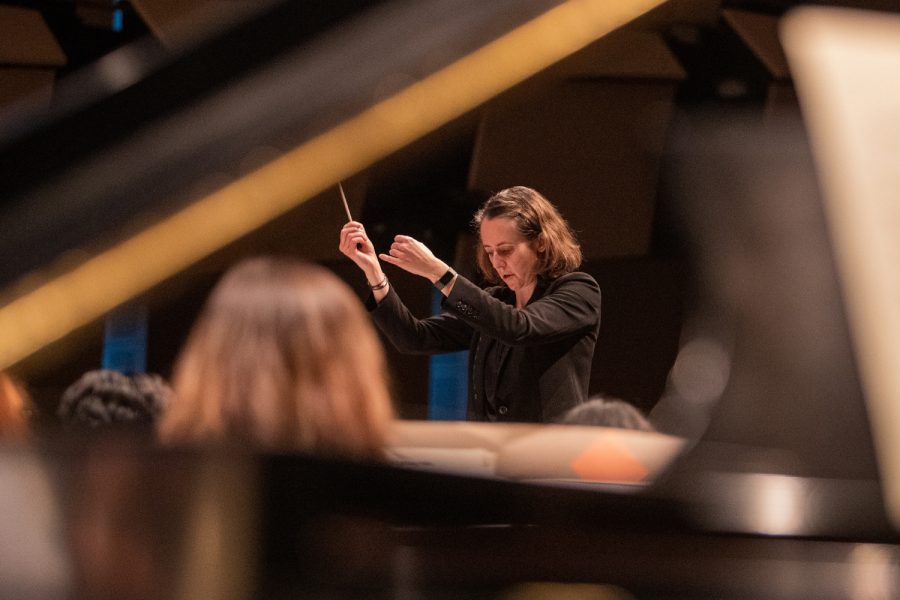 Melisse Brunet is shown conducting a rehearsal in the Concert Hall of the Voxman Music Building in Iowa City on Friday, Nov. 19, 2021. As her first semester at the University of Iowa, the centennial anniversary of the Iowa Symphony Orchestra is a huge responsibility to uphold, but by 