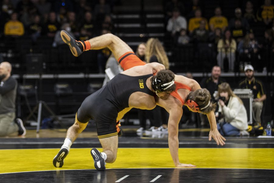 Iowa’s 133-pound Austin DeSanto works to take down Princeton’s Nick Masters during a season opening dual wrestling meet between No. 1 Iowa and No. 21 Princeton at Carver-Hawkeye Arena on Friday, Nov. 19, 2021. DeSanto won by tech fall 22-6. The Hawkeyes defeated the Tigers with a team score of 32-12.