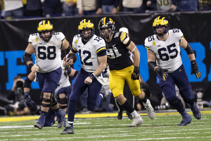 Michigan quarterback Cade McNamara carries the ball during the Big Ten Championship game between No. 13 Iowa and No. 2 Michigan at Lucas Oil Stadium in Indianapolis, Indiana, on Saturday, Dec. 4, 2021. (Grace Smith/The Daily Iowan)