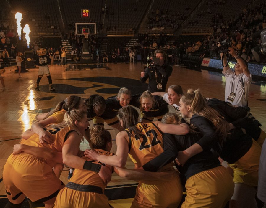 Iowa huddles together before a women’s basketball game between No. 9 Iowa and Michigan State at Carver-Hawkeye Arena in Iowa City on Sunday Dec. 5, 2021. The Hawkeyes defeated the Trojans 88-61. (Dimia Burrell/The Daily Iowan)