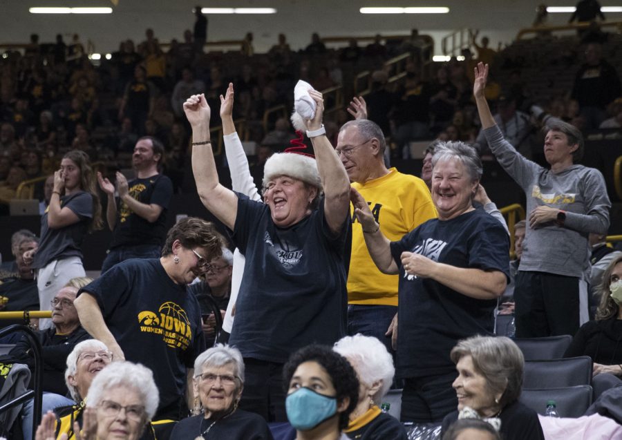 Iowa fans celebrate during a women’s basketball game between No. 9 Iowa and Michigan State at Carver-Hawkeye Arena in Iowa City on Sunday Dec. 5, 2021. 6,942 fans attended the game. The Hawkeyes defeated the Trojans, 88-61.