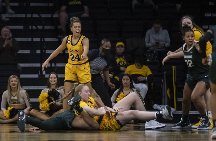 Iowa guard Gabbie Marshall points towards her teammate and a Michigan State player after a physical play during a women’s basketball game between No. 9 Iowa and Michigan State at Carver-Hawkeye Arena in Iowa City on Sunday Dec. 5, 2021. The Hawkeyes defeated the Trojans 88-61. (Dimia Burrell/The Daily Iowan)