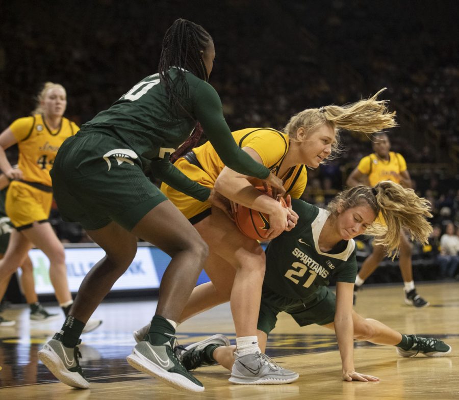 Iowa guard Sydney Affolter is double teamed by Michigan State guard Laurel Jacqmain and forward Jayla James. The Hawkeyes had 11 turnovers and the Trojans had 19 during a women’s basketball game between No. 9 Iowa and Michigan State at Carver-Hawkeye Arena in Iowa City on Sunday Dec. 5, 2021. The Hawkeyes defeated the Trojans 88-61. (Dimia Burrell/The Daily Iowan)