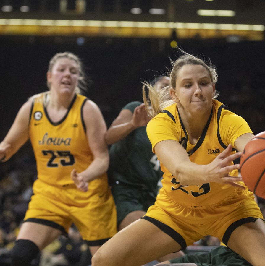 Iowa forward Logan Cook saves a ball from going out of bounds during a women’s basketball game between No. 9 Iowa and Michigan State at Carver-Hawkeye Arena in Iowa City on Sunday Dec. 5, 2021. Cook was one of the four non-starters to score, helping the Hawkeyes defeat the Trojans, 88-61. (Dimia Burrell/The Daily Iowan)