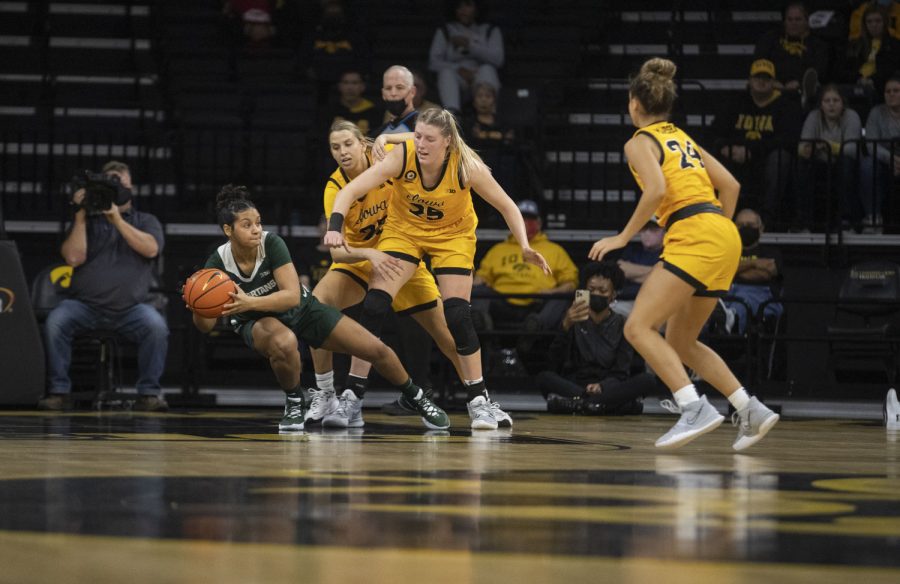 Michigan State guard Moira Joiner is double teamed by Iowa forwards Monika Czinano and Logan Cook. Michigan State finished with 19 turnovers during a women’s basketball game between No. 9 Iowa and Michigan State at Carver-Hawkeye Arena in Iowa City on Sunday Dec. 5, 2021. The Hawkeyes defeated the Trojans, 88-61. 