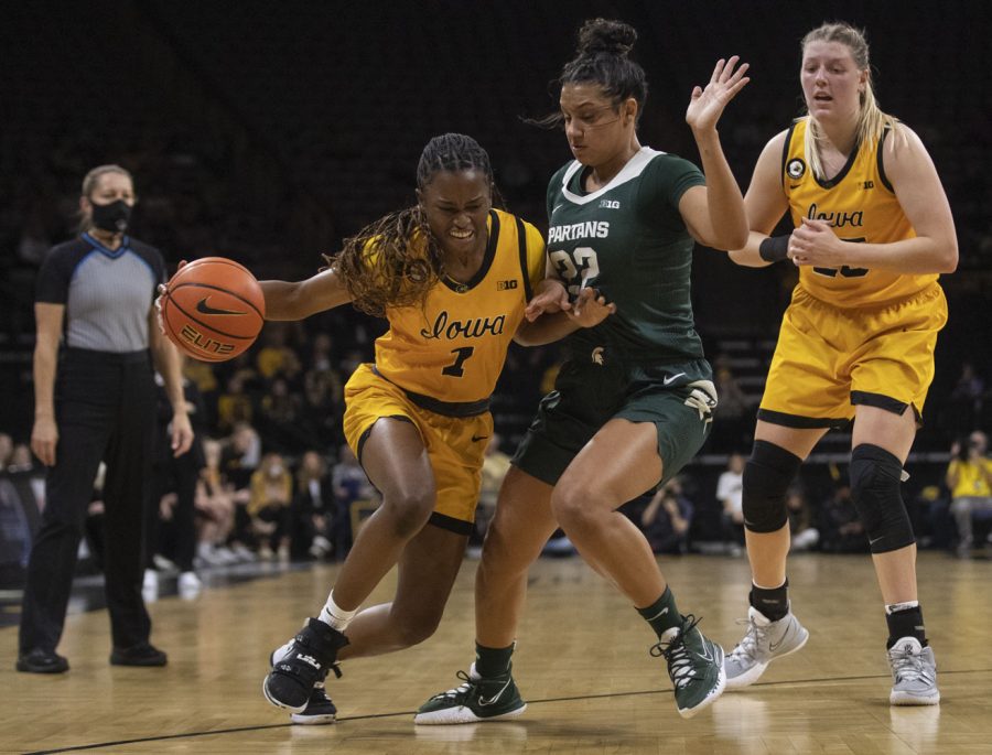 Iowa guard Tomi Taiwo works to drive to the basket around Michigan State guard Moira Joiner during a women’s basketball game between No. 9 Iowa and Michigan State at Carver-Hawkeye Arena in Iowa City on Sunday, Dec. 5, 2021. Taiwo was one of the four non-starters to score, helping the Hawkeyes defeat the Trojans, 88-61. 