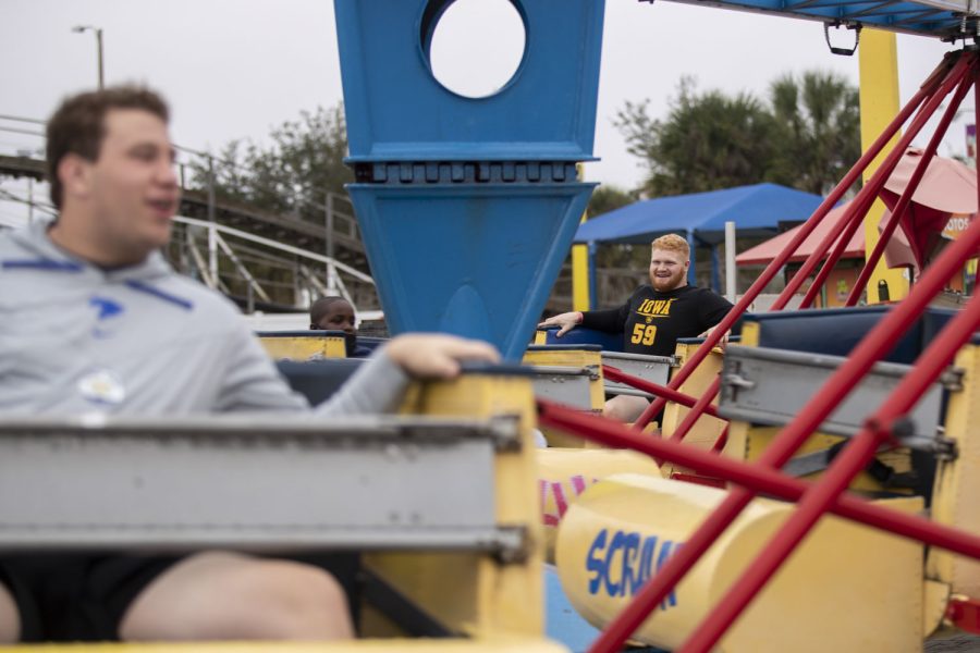 Iowa defensive lineman Griffin Little smiles while on a ride during the Vrbo Citrus Bowl Day for Kids at Fun Spot America Theme Park in Orlando, Fla., on Thursday, Dec. 30, 2021. Citrus Bowl Day for Kids is a 2022 Vrbo Citrus Bowl sponsored event that hosts both Iowa and Kentucky. Players from both teams grouped up with children and participated in rides and various activities around the theme park.