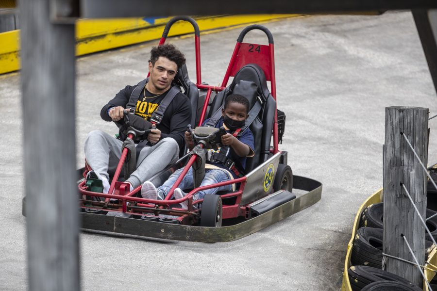 Iowa wide receiver Arland Bruce IV drives a go kart with a kid during the Vrbo Citrus Bowl Day for Kids at Fun Spot America Theme Park in Orlando, Fla., on Thursday, Dec. 30, 2021. Citrus Bowl Day for Kids is a 2022 Vrbo Citrus Bowl sponsored event that hosts both Iowa and Kentucky. Players from both teams grouped up with children and participated in rides and various activities around the theme park.