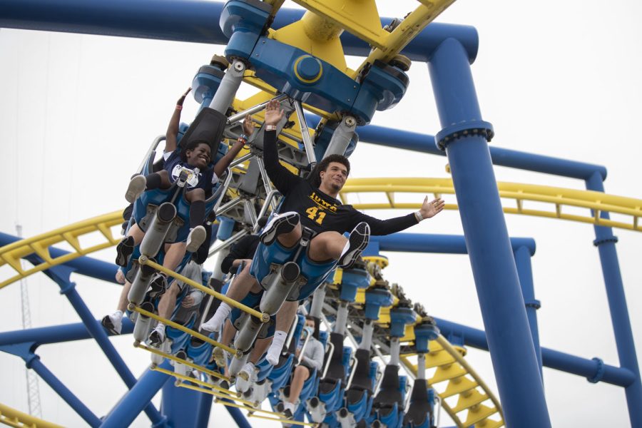 Iowa linebacker Jaden Harrell and his paired child Andre Jones put their hands up on a roller coaster during the Vrbo Citrus Bowl Day for Kids at Fun Spot America Theme Park in Orlando, Fla., on Thursday, Dec. 30, 2021. Citrus Bowl Day for Kids is a 2022 Vrbo Citrus Bowl sponsored event that hosts both Iowa and Kentucky. Players from both teams grouped up with children and participated in rides and various activities around the theme park.