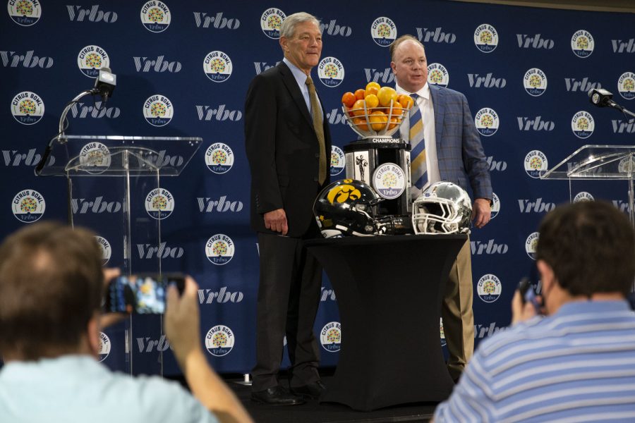Iowa head coach Kirk Ferentz and Kentucky head coach Mark Stoops pose for a photo with the Citrus Bowl Trophy during a head coach press conference for the 2022 Vrbo Citrus Bowl at Rosen Plaza Hotel in Orlando, Fla., on Friday, Dec. 31, 2021. Ferentz is in his 23rd season as head coach at Iowa. Stoops is in his 9th season as head coach at Kentucky. The longest tenured coach in college football, Kirk Ferentz, noted respect for Stoops’ tenure. I dont know how many coaches have been in one program for nine years. Its probably a small number.