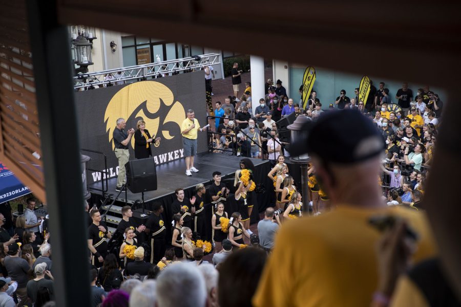 Fans observe radio play-by-play commentator Gary Dolphin during a pep rally event for both Iowa and Kentucky fans at The Pointe in Orlando, Fla., on Friday, Dec. 31, 2021. Dolphin said he knew who the starting quarterback for Iowa would be for Saturday’s game but did not announce because of his friendship with Iowa head coach Kirk Ferentz.Hawkeyes and Wildcats attended the event before the 2022 Vrbo Citrus Bowl tomorrow on New Years Day.
