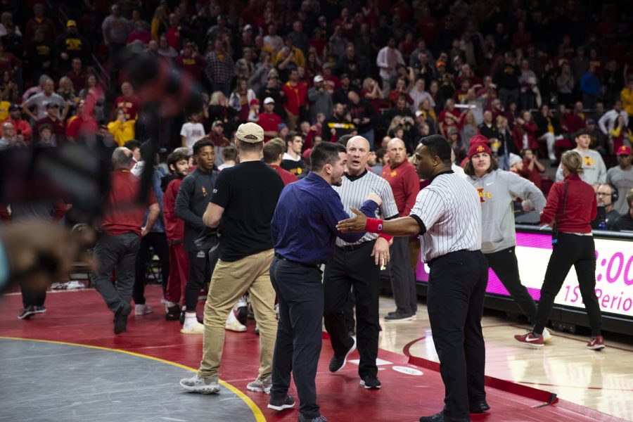 Iowa+State+assistant+coach+Brent+Metcalf+speaks+with+a+referee+after+a+conflict+broke+out+after+a+wrestling+meet+betwen+No.+1+Iowa+and+No.+13+Iowa+State+at+Hilton+Coliseum+in+Ames%2C+Iowa+on+Sunday%2C+Dec.+5%2C+2021.+The+Hawkeyes+defeated+the+Cyclones%2C+22-11.