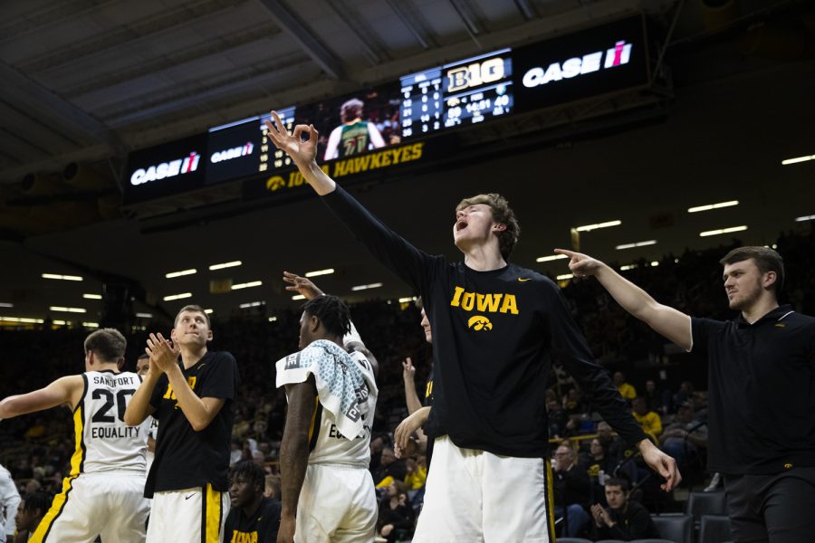 The Iowa bench celebrates after Iowa scores during a basketball game between Iowa and Southeastern Louisiana at Carver-Hawkeye Arena in Iowa City on Tuesday, Dec. 21, 2021. The Hawkeyes defeated the Lions 93-62. 