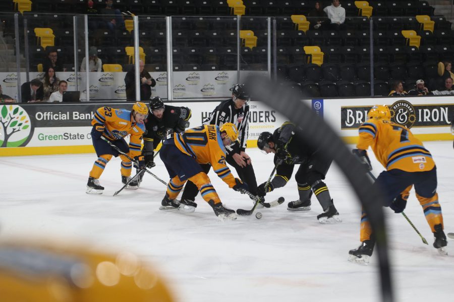 A referee drops the puck during a face-off at a hockey game between the Iowa Heartlanders and Toledo Walleye at Xtream Arena in Coralville, Iowa, on Wednesday, Dec. 8, 2021. The Walleye defeated the Heartlanders 4-0. 