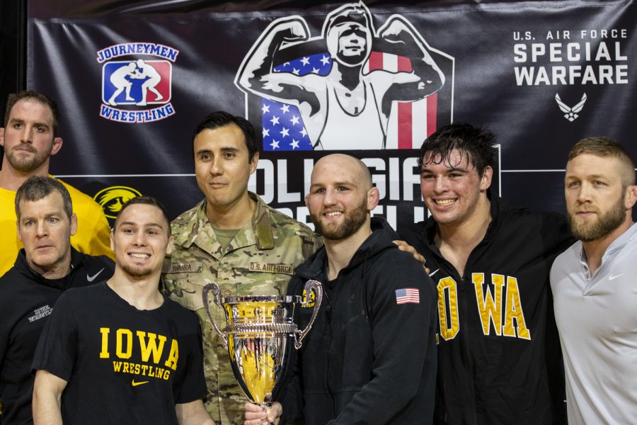 Members of the Iowa Wrestling team pose with the championship trophy after the red pool championship match-up of the National Collegiate Duals between Iowa and North Carolina State at Northwest Florida State College in Niceville, FL on Tuesday, Dec. 21, 2021. The Hawkeyes defeated the Wolfpack 19-15. 