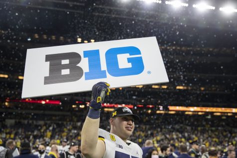 Michigan offensive lineman Mica Gelb holds up a “B1G” sign after the Big Ten Championship game between No. 13 Iowa and No. 2 Michigan at Lucas Oil Stadium in Indianapolis, Indiana, on Saturday, Dec. 4, 2021. The Wolverines became Big Ten Champions after defeating the Hawkeyes, 42-3. 