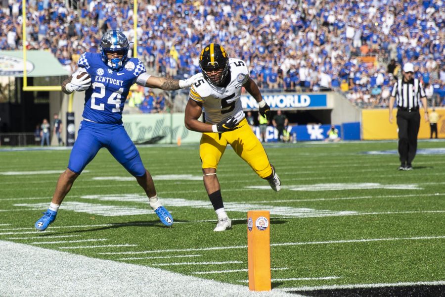Kentucky running back Chris Rodriguez Jr. stiff arms Iowa linebacker Jestin Jacobs during the 2022 Vrbo Citrus Bowl between No. 15 Iowa and No. 22 Kentucky at Camping World Stadium in Orlando, Fla., on Saturday, Jan. 1, 2022. Rodriguez Jr.’s longest carry went for 13 yards. The Wildcats defeated the Hawkeyes, 20-17.