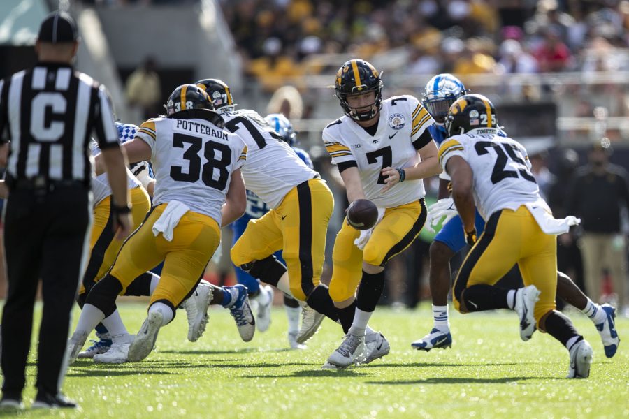 Iowa quarterback Spencer Petras hands the ball off to running back Gavin Williams during the 2022 Vrbo Citrus Bowl between No. 15 Iowa and No. 22 Kentucky at Camping World Stadium in Orlando, Fla., on Saturday, Jan. 1, 2022. Williams started in place of Tyler Goodson after Goodson declared for the 2022 NFL Draft. Williams rushed for 98 yards on 16 carries. The Wildcats defeated the Hawkeyes, 20-17.