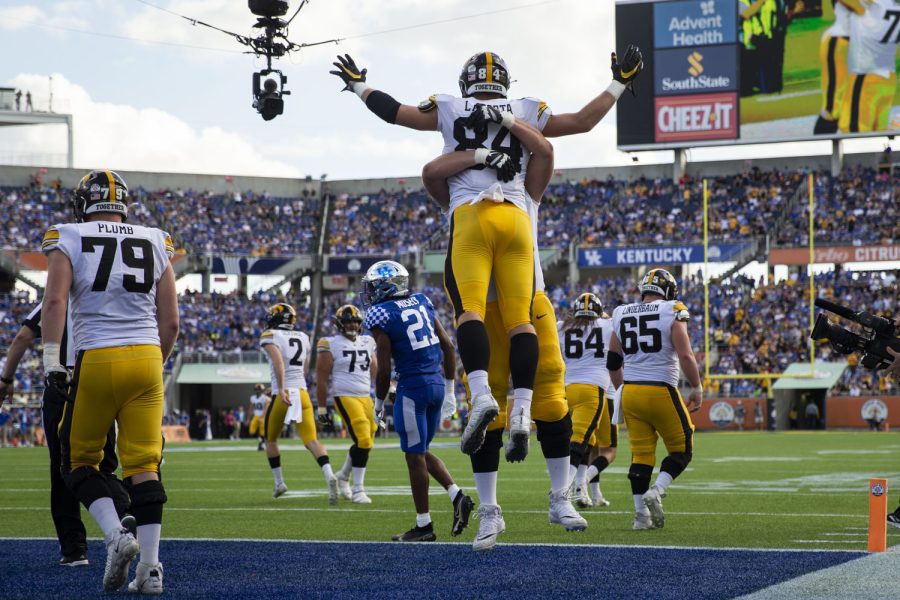 Iowa offensive lineman Mason Richman lifts up Iowa tight end Sam LaPorta during the 2022 Vrbo Citrus Bowl between No. 15 Iowa and No. 22 Kentucky at Camping World Stadium in Orlando, Fla., on Saturday, Jan. 1, 2022. The Wildcats defeated the Hawkeyes, 20-17.