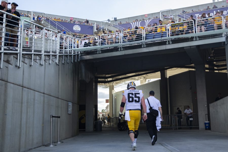 Iowa center Tyler Linderbaum heads to the locker room after an injury during the 2022 Vrbo Citrus Bowl between No. 15 Iowa and No. 22 Kentucky at Camping World Stadium in Orlando, Fla., on Saturday, Jan. 1, 2022. The Wildcats defeated the Hawkeyes, 20-17.