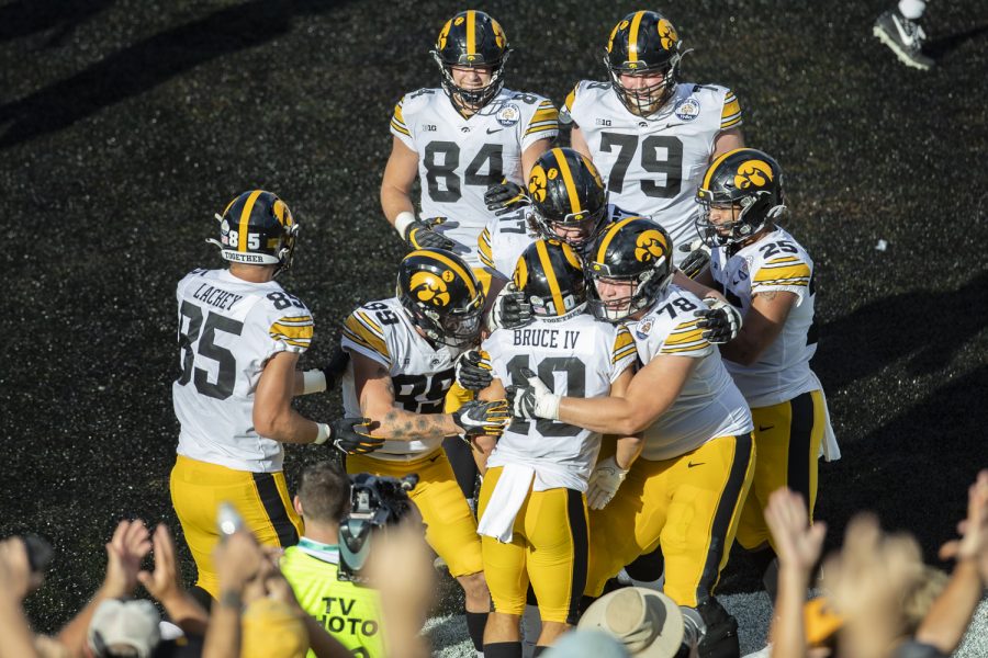 Iowa wide receiver Arland Bruce IV celebrates a touchdown with teammates during the 2022 Vrbo Citrus Bowl between No. 15 Iowa and No. 22 Kentucky at Camping World Stadium in Orlando, Fla., on Saturday, Jan. 1, 2022. The Wildcats defeated the Hawkeyes, 20-17.