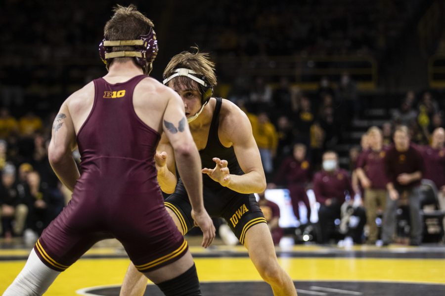 Iowa’s 125-pound Drake Ayala battles Minnesota’s No. 7 ranked Patrick McKee during a wrestling meet between No. 1 Iowa and No. 14 Minnesota at Carver-Hawkeye Arena on Friday, Jan. 7, 2022. Ayala lost by decision, 13-7. The Hawkeyes defeated the Gophers, 22-10.