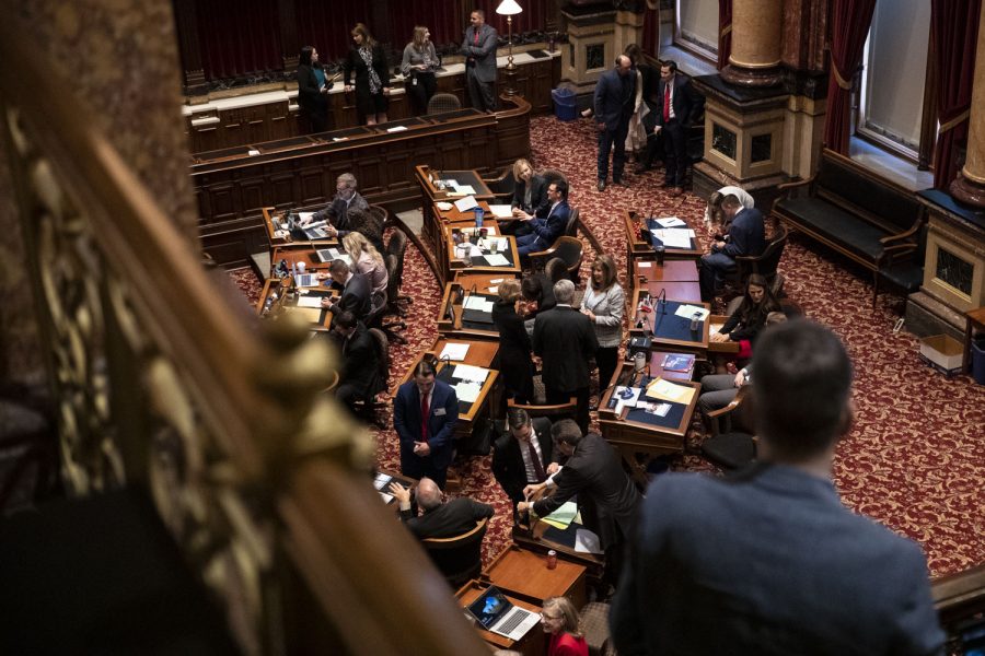 Members of the Senate congregate in the Senate Chamber during the opening of the 2022 Legislative Session at the Iowa State Capitol in Des Moines, Iowa, on Monday, Jan. 10, 2022. Both the House and Senate Republican leaders said the priority of this session is to return tax funds and address workforce conditions. 