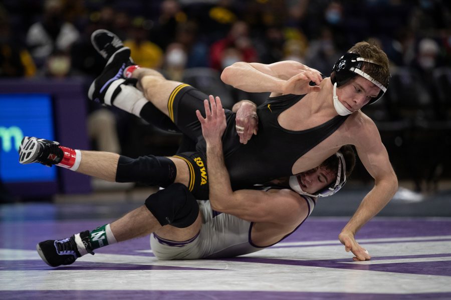 Iowa’s 133-pound Cullen Schriever wrestles Northwestern’s No. 9 Chris Cannon during a dual at Welsh-Ryan Arena in Evanston, IL. Cannon defeated Schriever by decision 4-3. Schriever removed his redshirt and made his varsity debut. 